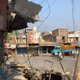 At Talab Chowk, a banner from the Ram Navami procession can still be seen amidst the rubble of demolished shops.